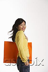 AsiaPix - Woman holding large shopping bag.