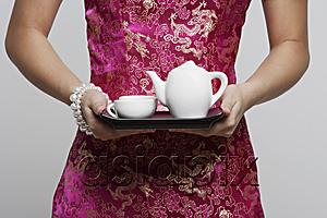 AsiaPix - cropped shot of woman wearing pink cheongsam holding tea