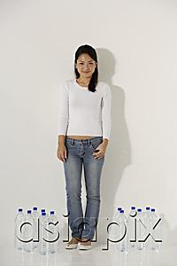 AsiaPix - Young Asian woman standing near water bottles