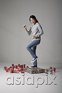 AsiaPix - Young Asian woman jumping on cans