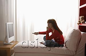 AsiaPix - Asian girl watching TV in her bedroom