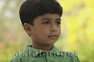Asia Images Group - serious little boy wearing green shirt