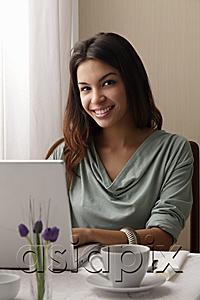 AsiaPix - young woman working on a laptop at a cafe