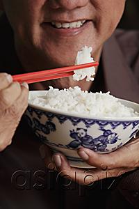 AsiaPix - cropped shot of mature man holding chopsticks and bowl of rice