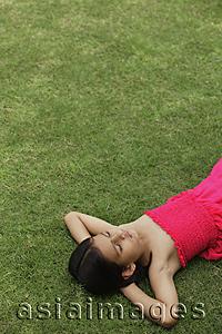 Asia Images Group - little girl in pink dress sleeping in park