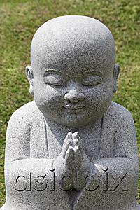AsiaPix - Close up of Buddhist statue praying