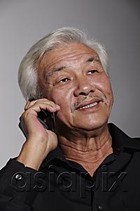 AsiaPix - Mature Chinese man talking on phone