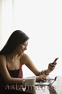 Asia Images Group - woman looking at text messages