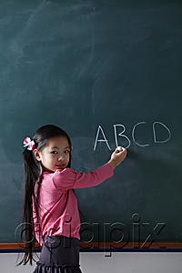 AsiaPix - young girl writing on chalk board
