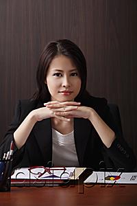 AsiaPix - Young woman sitting at desk smiling