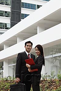 AsiaPix - man and woman wearing suits standing in front of building