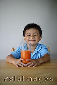 Asia Images Group - Little boy holding glass of juice
