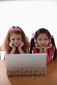 AsiaPix - two young girls playing with laptop