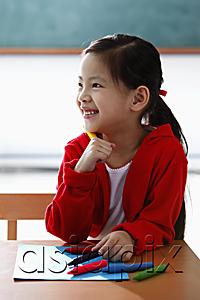 AsiaPix - Young girl holding crayon and smiling