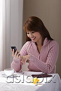 AsiaPix - Young woman looking at phone