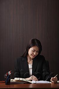AsiaPix - Woman working at her desk