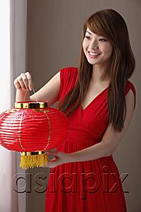 AsiaPix - Young Chines woman wearing red dress holding red lantern