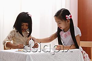AsiaPix - two little girls having a tea party