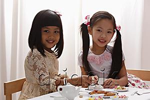 AsiaPix - two little girls having a tea pary