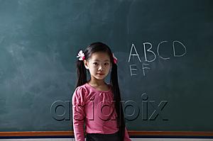 AsiaPix - young girl standing in front of chalk board