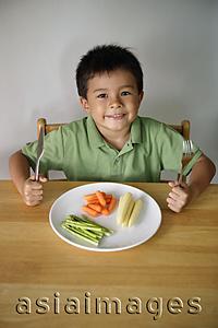 Asia Images Group - Little boy with plate of vegetables