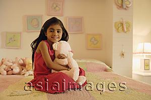 Asia Images Group - little girl with stuff bear on bed