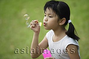 Asia Images Group - Girl blowing bubbles