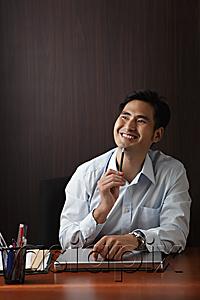 AsiaPix - Man sitting at desk smiling