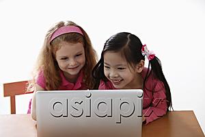 AsiaPix - two young girls looking at laptop