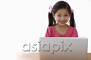 AsiaPix - Young Chinese girl playing on laptop