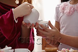 AsiaPix - close up of two girls playing tea party