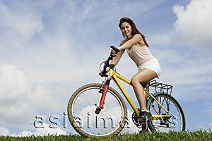 Asia Images Group - Woman on bicycle