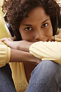 Mind Body Soul - Head shot of woman listening to music.