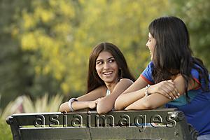 Asia Images Group - Two teen girls on park bench
