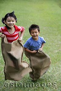 Asia Images Group - Kids having sack race