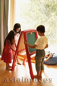 Asia Images Group - kids playing at easel