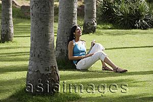 Asia Images Group - teen girl listening to music in park