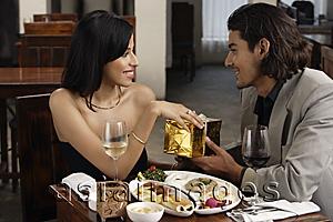 Asia Images Group - young man giving gift to young woman