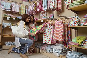 Asia Images Group - mother and daughter shopping for clothes