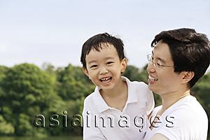 Asia Images Group - Father holding son in arms, both smiling
