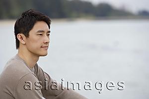 Asia Images Group - Profile of man sitting next to bay