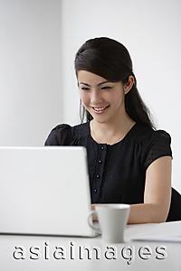 Asia Images Group - Young woman at computer