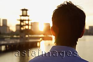 Asia Images Group - Young man looking into city skyline