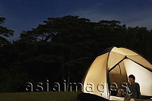 Asia Images Group - Man sitting in tent