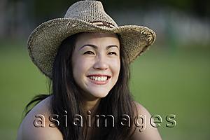 Asia Images Group - Young woman wearing straw cowboy hat
