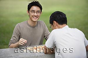 Asia Images Group - Two men playing Chinese chess in park