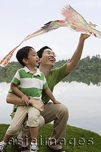 Asia Images Group - Father and son playing with kite