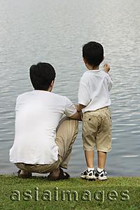 Asia Images Group - Father and son looking at lake