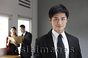 Asia Images Group - Businessman in foreground, colleagues in background