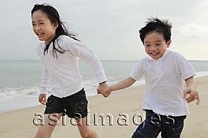 Asia Images Group - Boy and girl running on beach